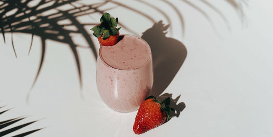 easy-to-make strawberry-banana smoothie in the shade of a plant