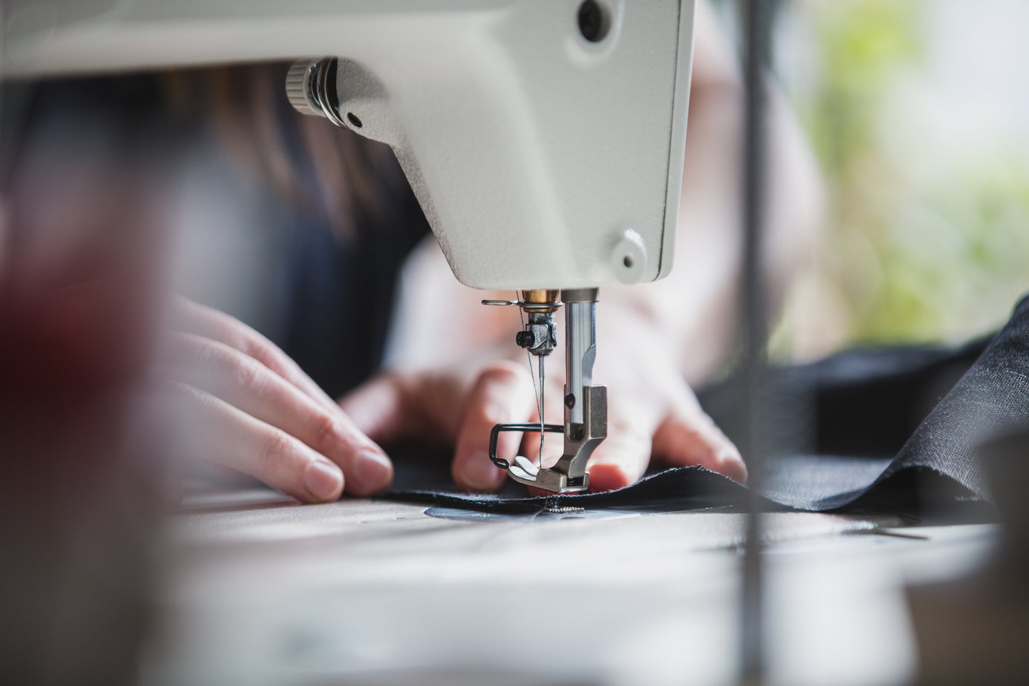 An artisan is sewing with a sewing machine