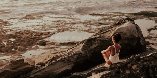 A girl meditating on a rock