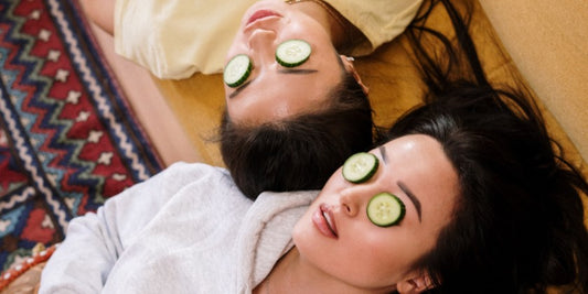 2 girls relaxing with cucumbers on their eyes
