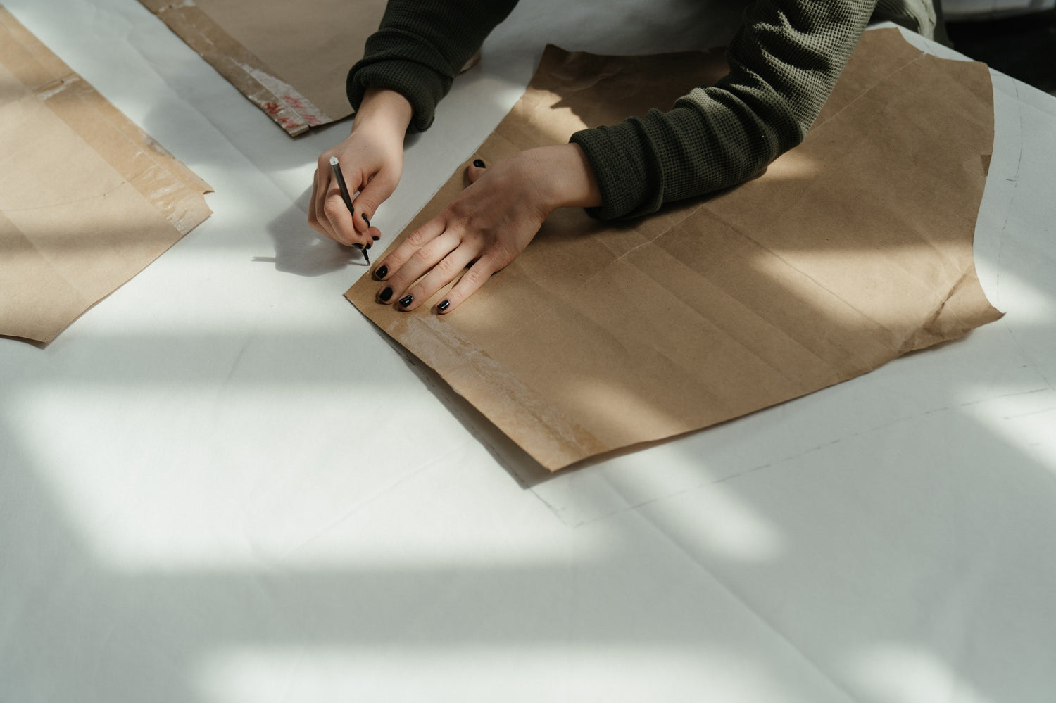 an artisan preparing a sewing pattern